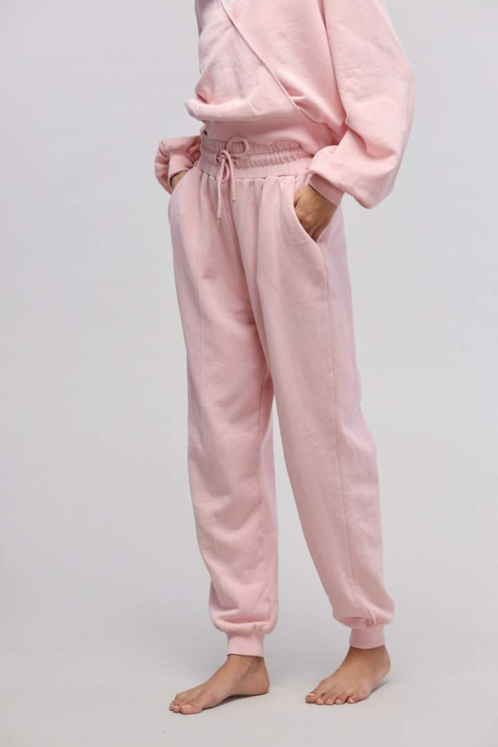 Pink Terry Travel Joggers with pockets and adjustable waistband for comfort.