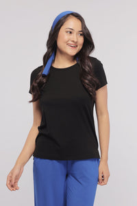 Black Supima® women’s tee styled with blue accessories for a chic look.