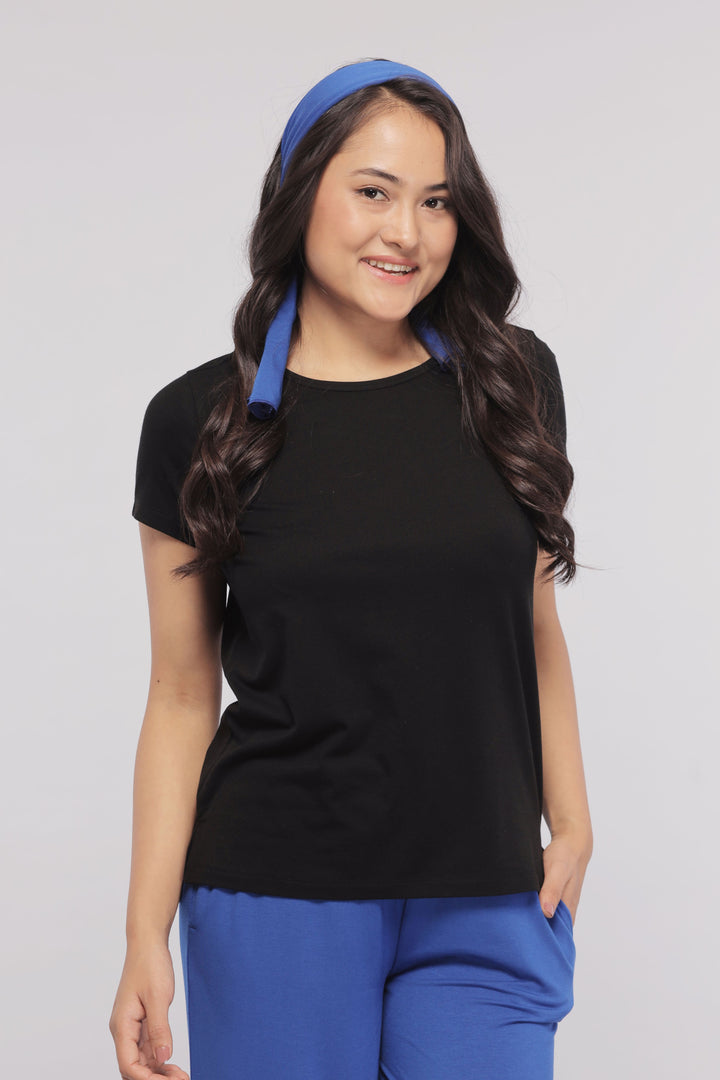 Black Supima® Women's Tee worn by smiling model with blue headband.