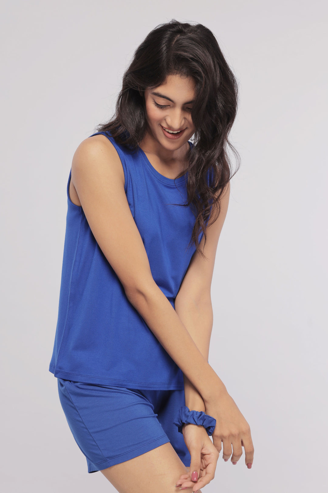 Model showcasing True Blue Shorts with matching top and scrunchie.