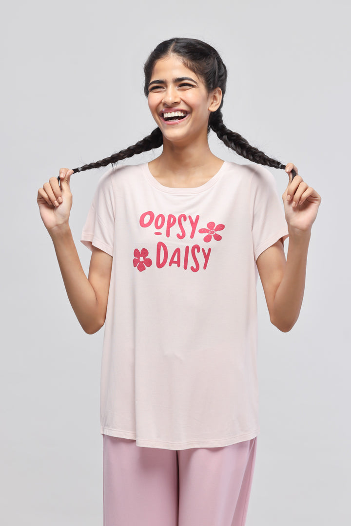 Oopsy Daisy flared pajama set model smiling and showing playful attire.