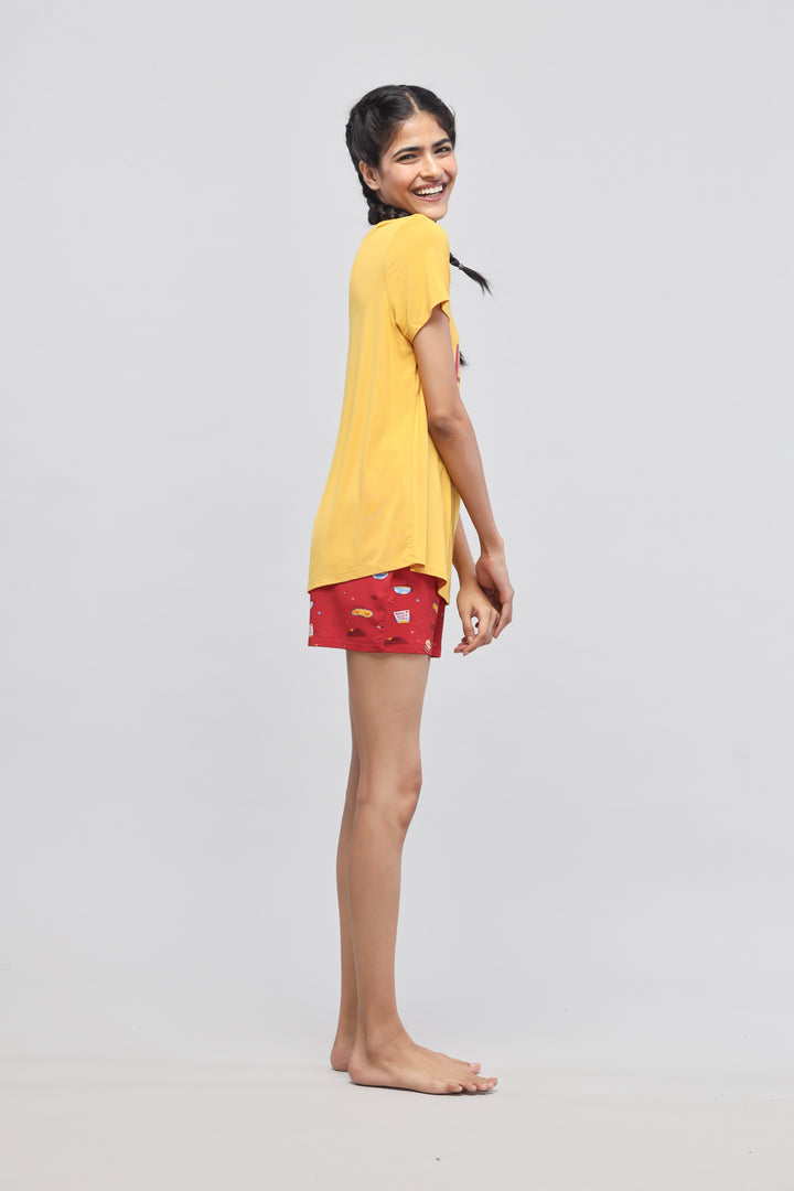 Self Love Shorts Set worn by model, bright yellow top and red shorts.