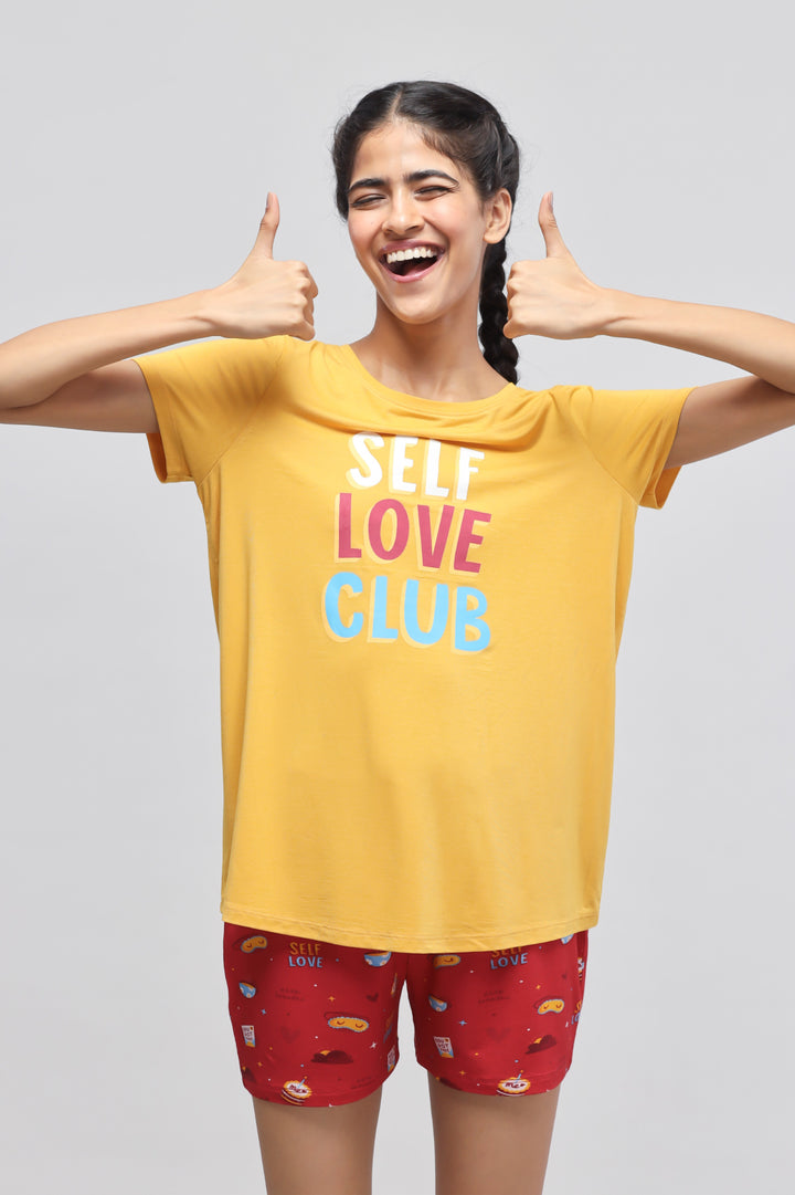 Self Love Shorts Set featuring vibrant yellow top and red patterned shorts.