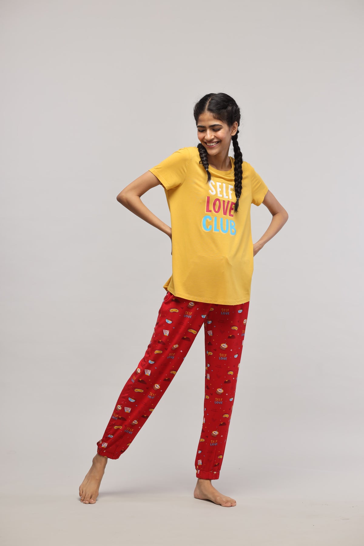 Self Love Cuff Pajama Set with cheerful yellow top and red pants.