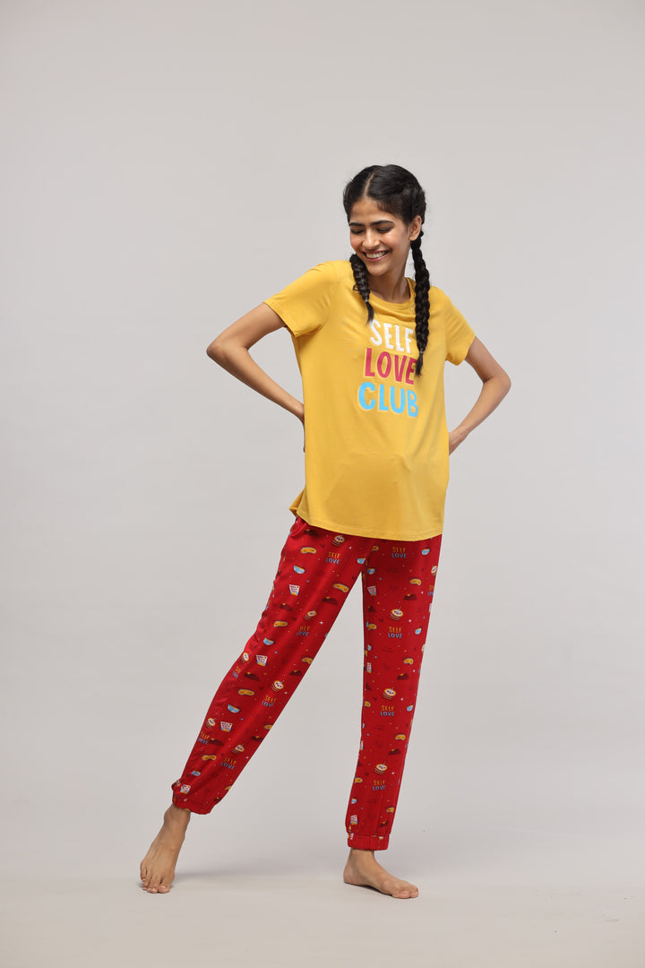 Self Love Cuff Pajama Set with cheerful yellow top and red pants.