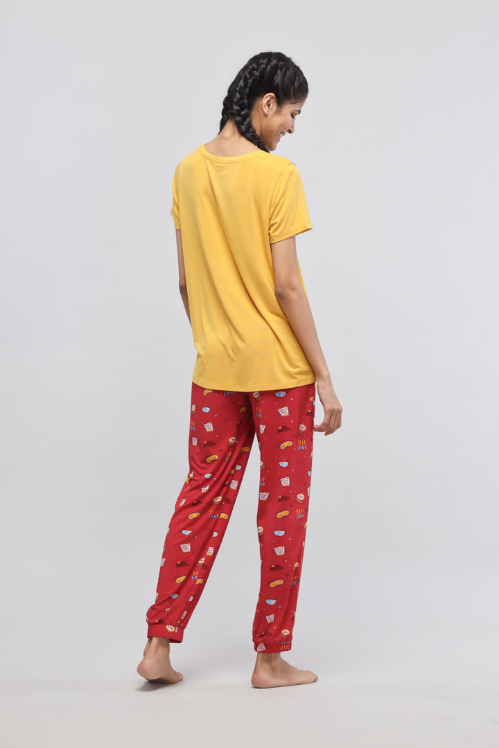 Self Love Cuff Pajama Set with yellow top and patterned red pants.