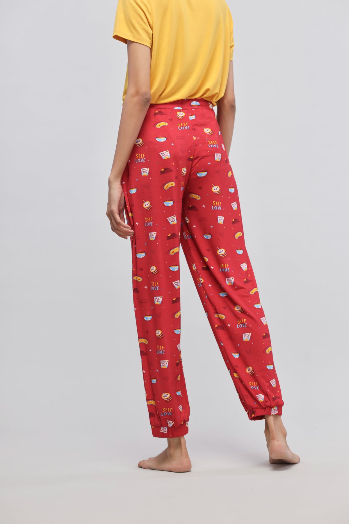Self Love Cuffed Pajamas in vibrant red with fun prints.