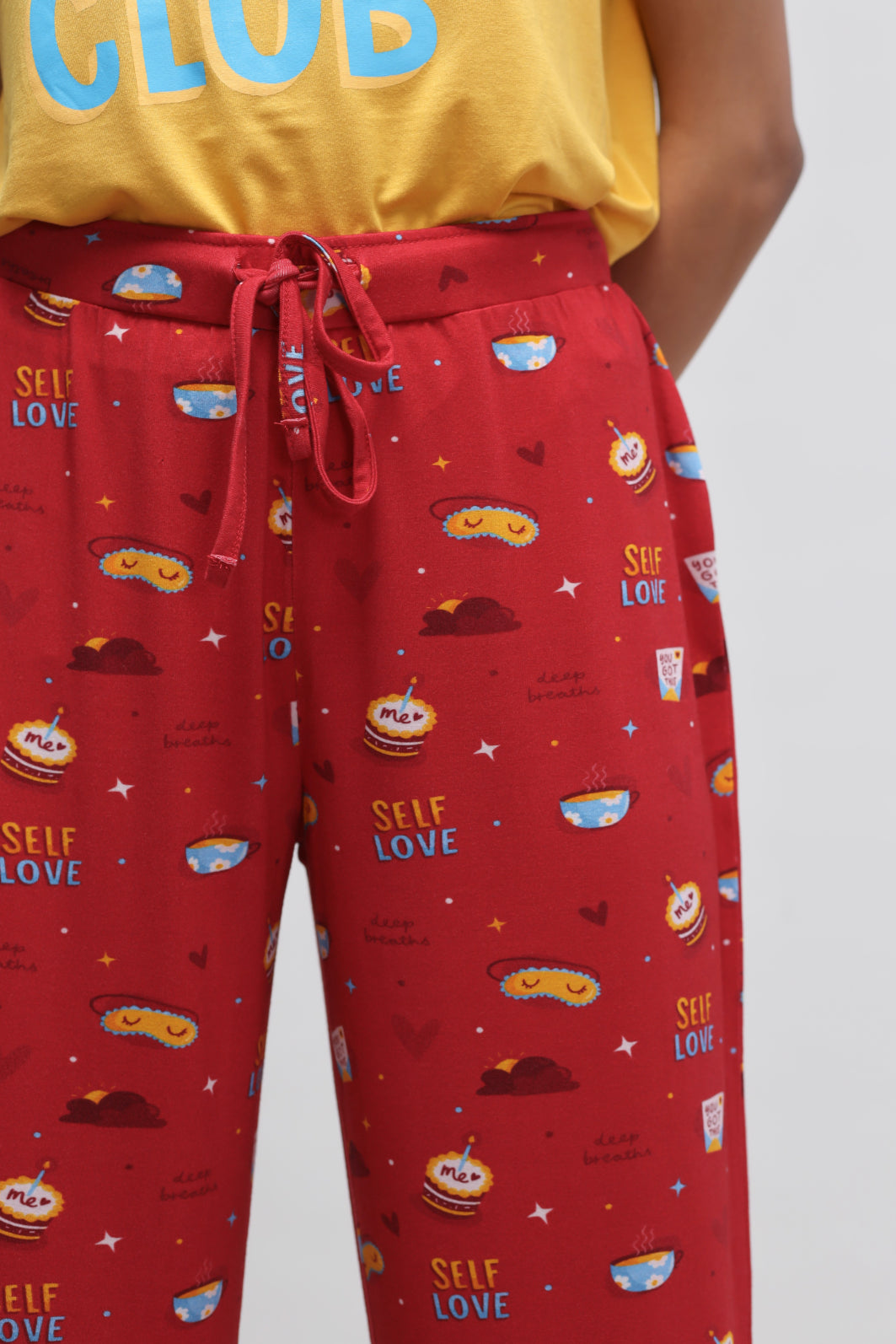 Red self-love cuffed pajamas with cute food-themed prints.