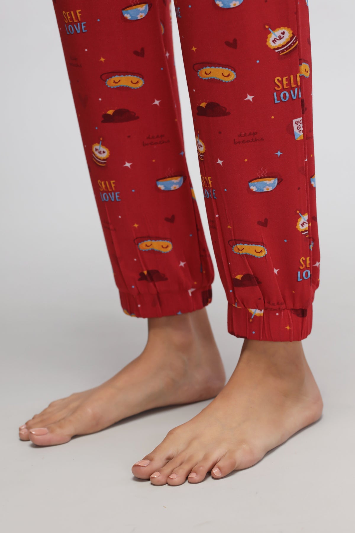 Self Love Cuffed Pajamas with playful food patterns and relaxed fit.