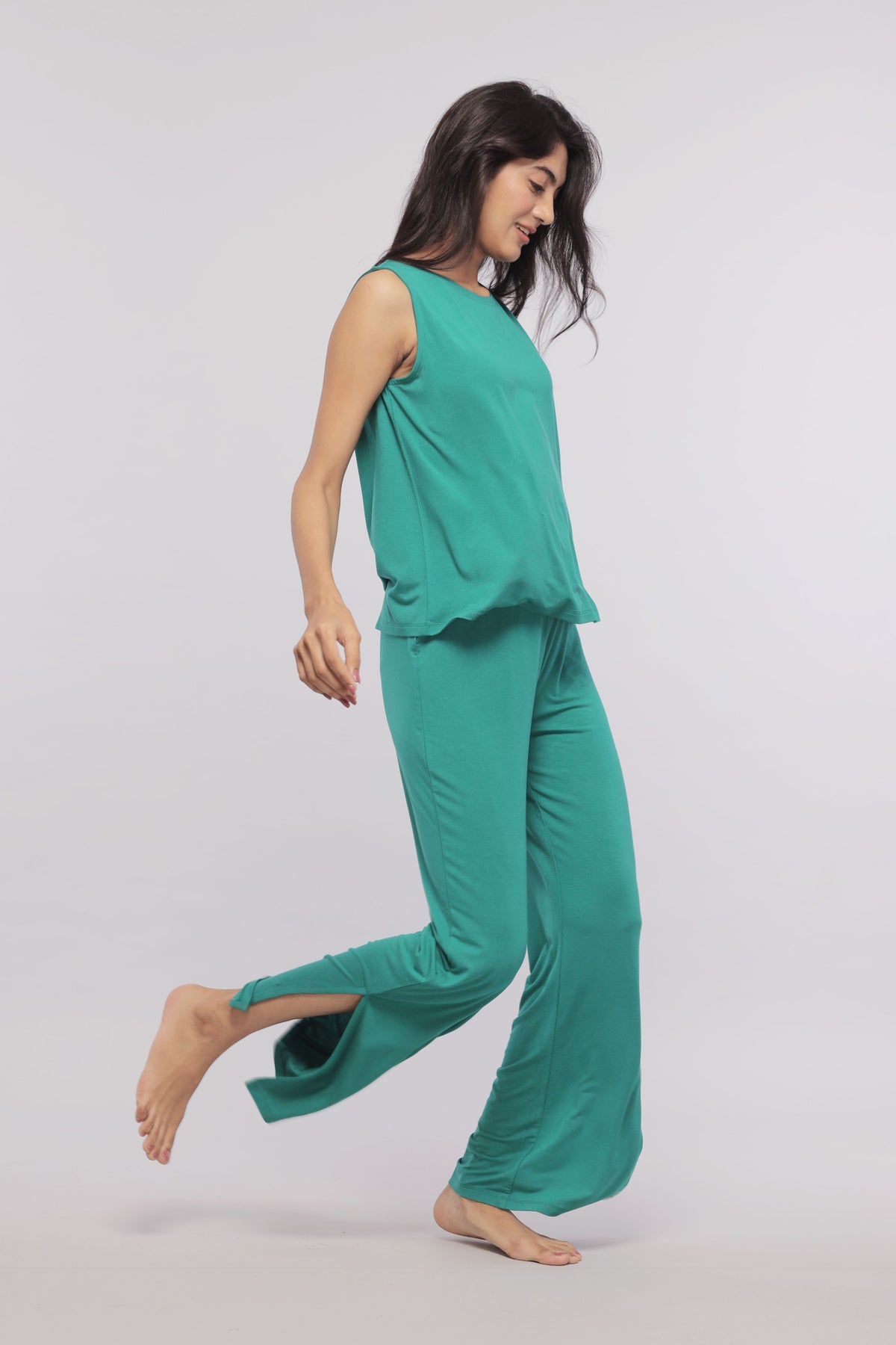 Green flared lounge pants with stylish side slits, perfect for comfort.