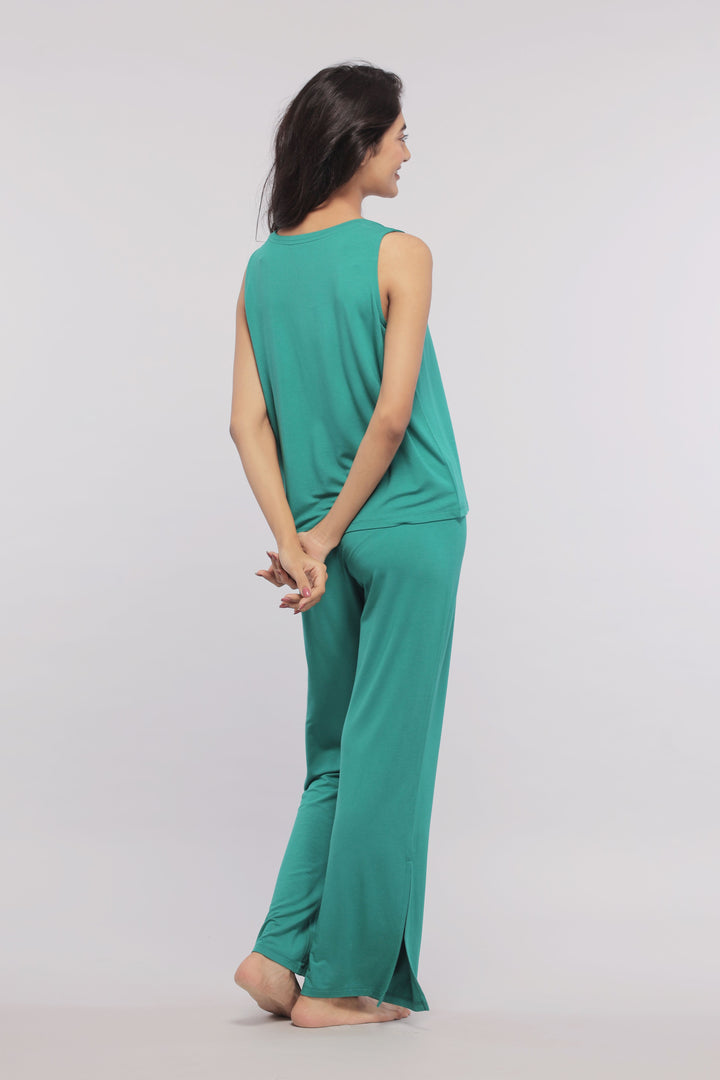 Green sleeveless cropped top styled with matching pants, perfect for casual wear.