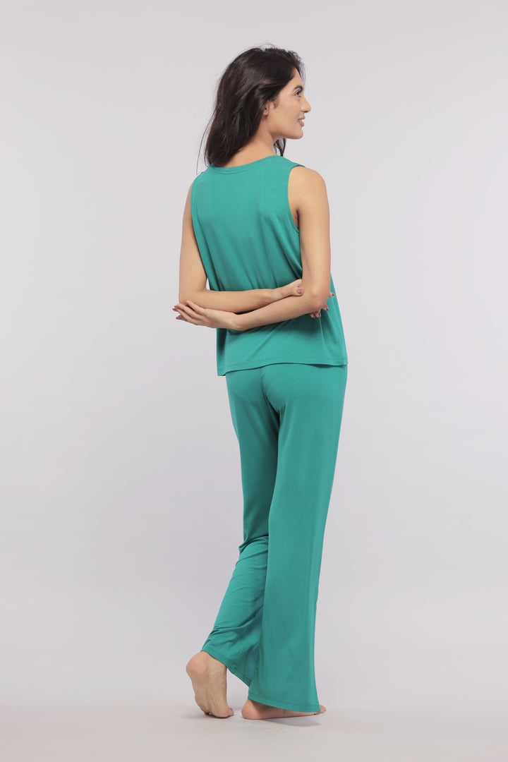 Green sleeveless cropped top worn with matching pants, back view.