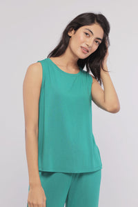 Green sleeveless cropped top displayed on a young woman.