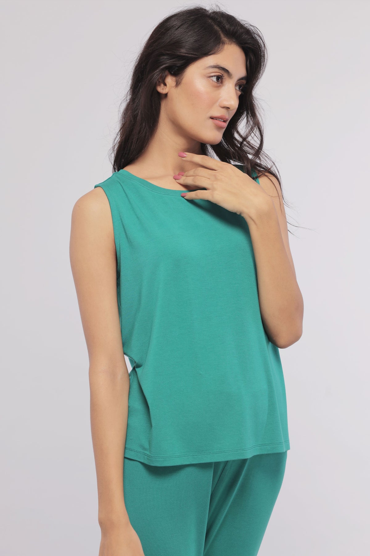 Green sleeveless cropped top worn by a woman, stylish and trendy.