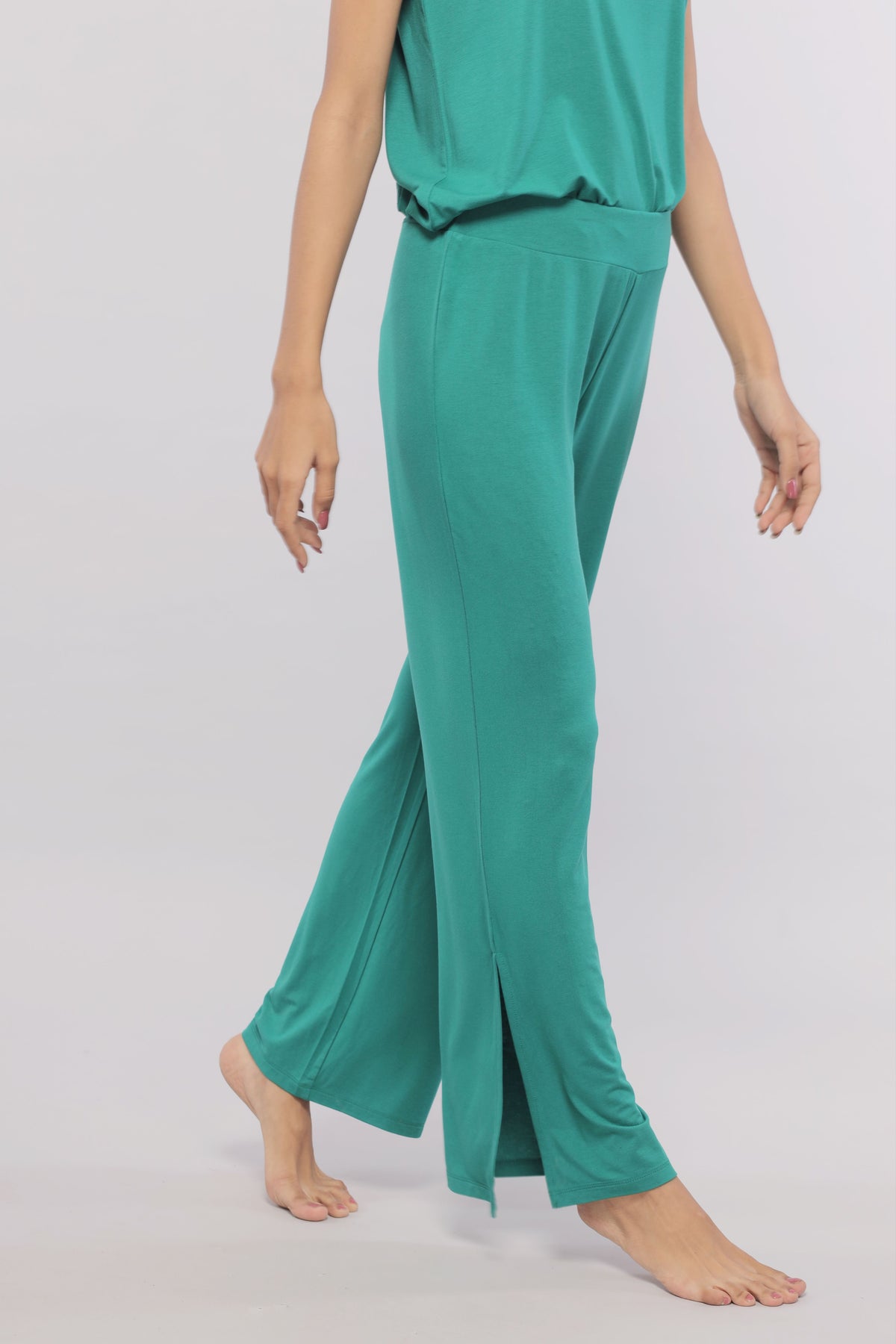 Green flared lounge pants with stylish side slits for comfort and fashion.