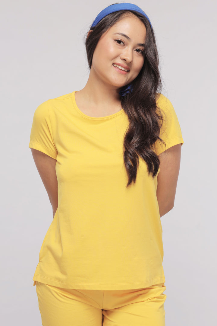 Cheerful model wearing sunny lime Supima® shorts set, perfect for summer.