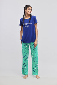 Blue "Snuggle is real" pajama set with patterned green pants.