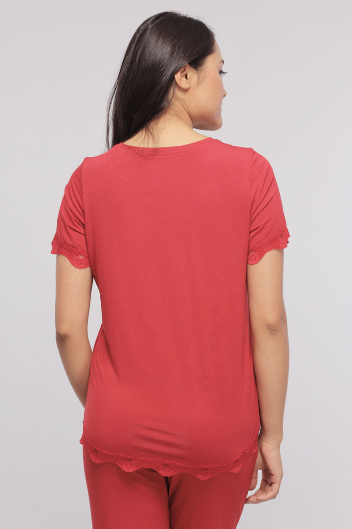 Back view of a woman wearing a romantic red lace top.