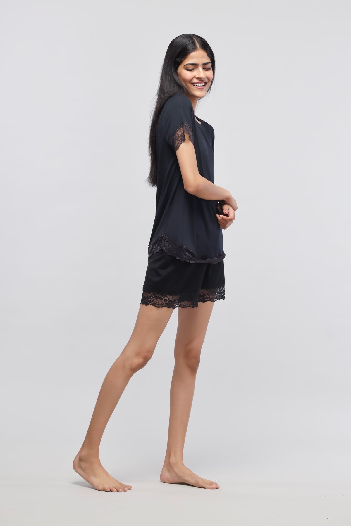 Delicate black lace top paired with stylish shorts for women.