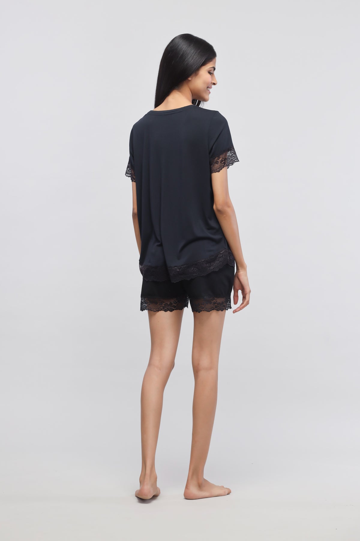 Delicate black lace top and shorts set for women.