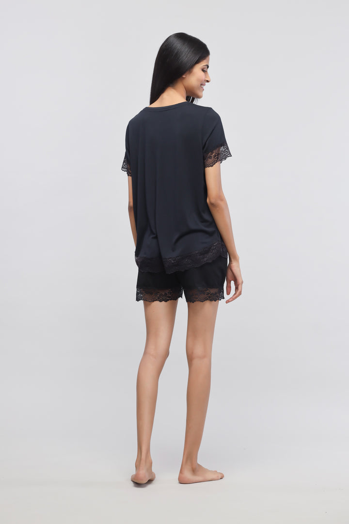 Delicate black lace shorts set with stylish top, back view model shot.
