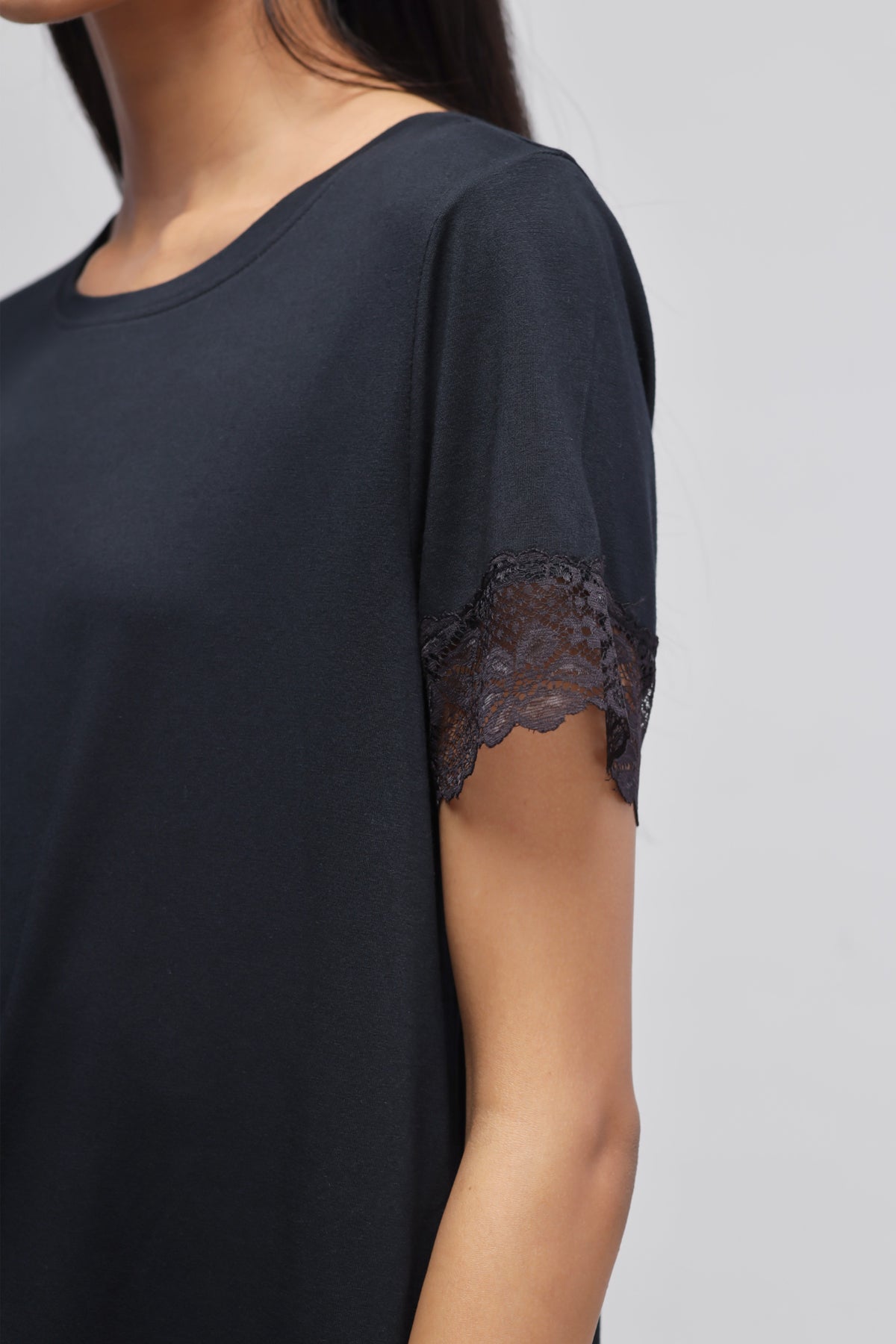 Delicate black lace top with elegant lace sleeve detail.