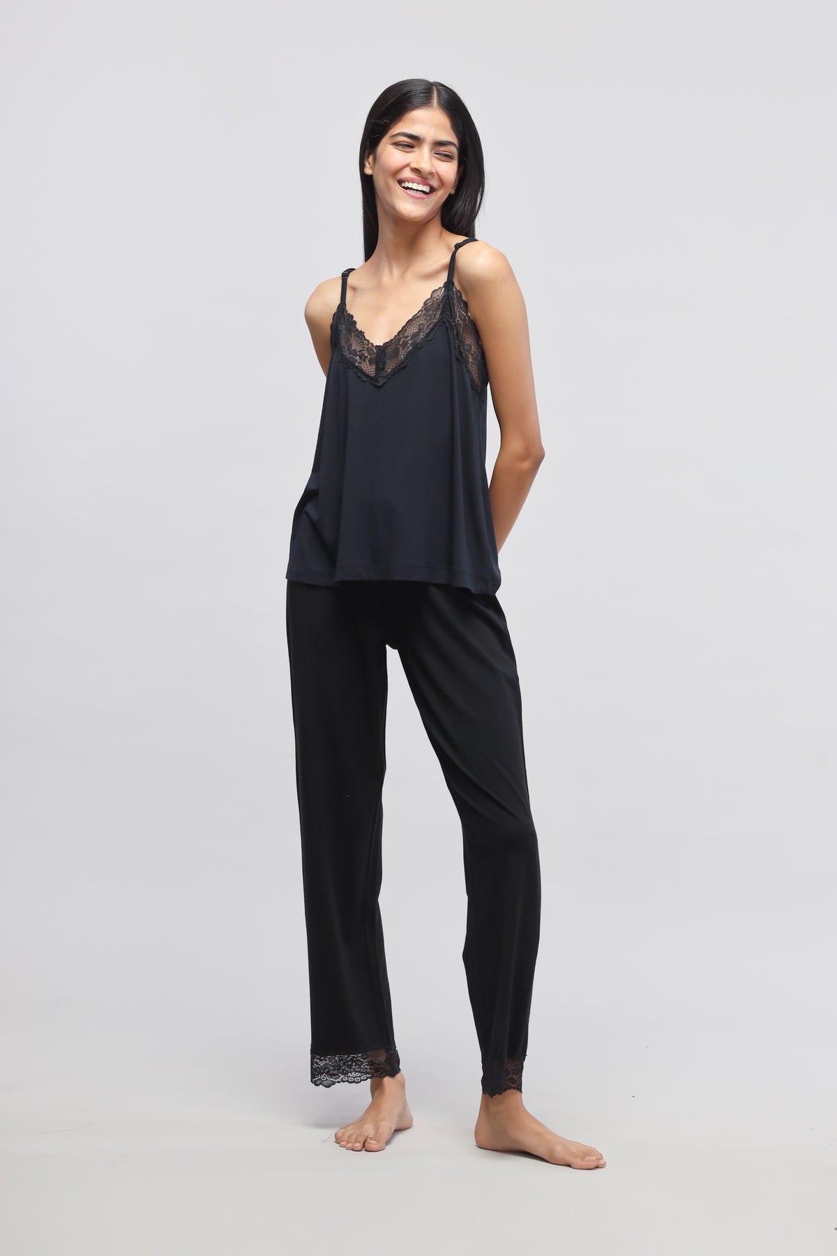 Delicate black lace tank top styled with matching black pants.
