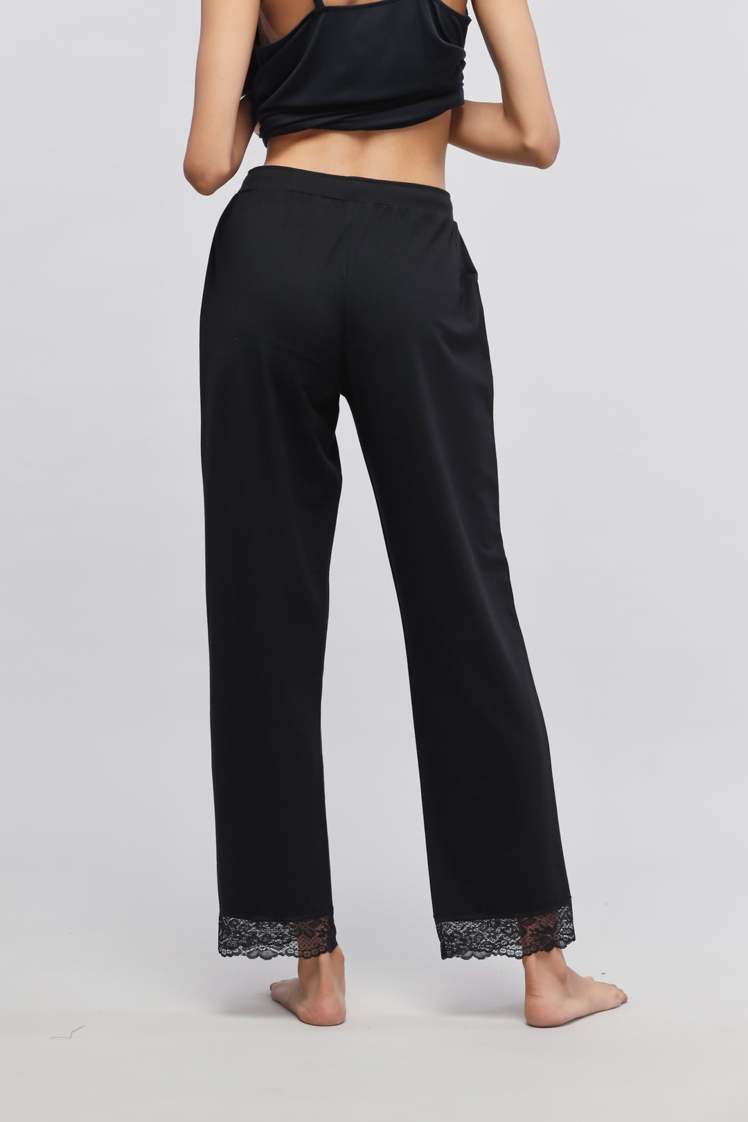 Delicate black lace pajama set with elegant lace-trimmed pants.