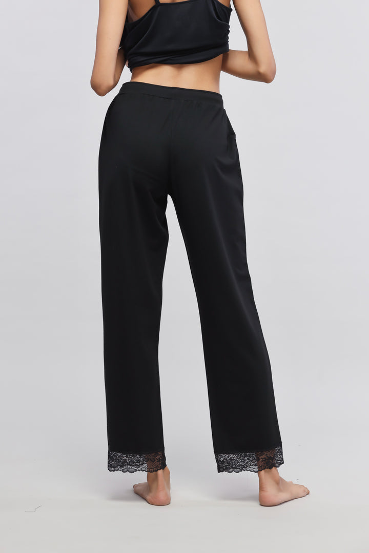 Delicate black lace pajama set with elegant lace-trimmed pants.