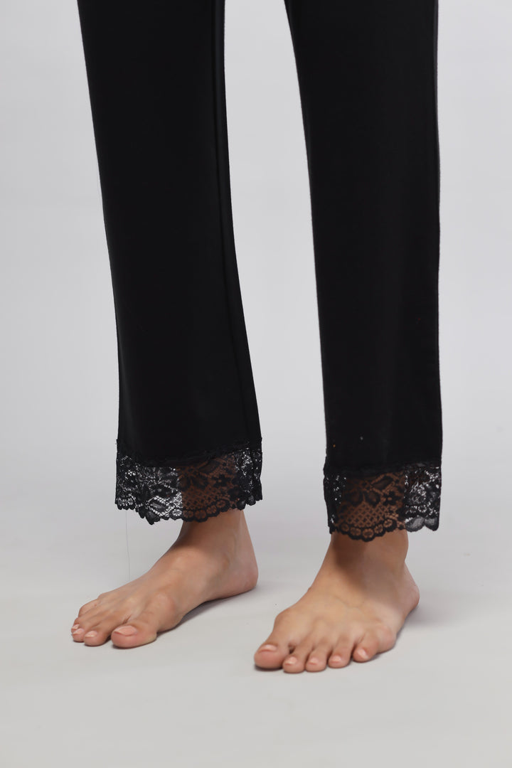 Delicate black lace pajama set with elegant lace trim and soft fabric.