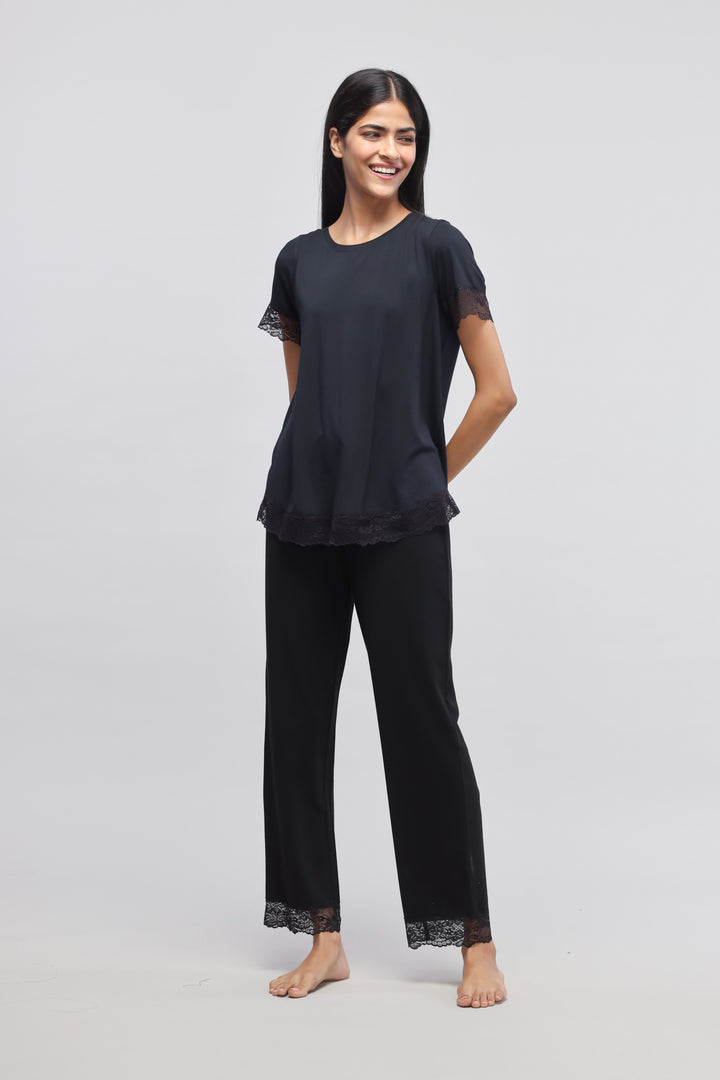 Delicate black lace pajama set with stylish short sleeves and elegant finish.
