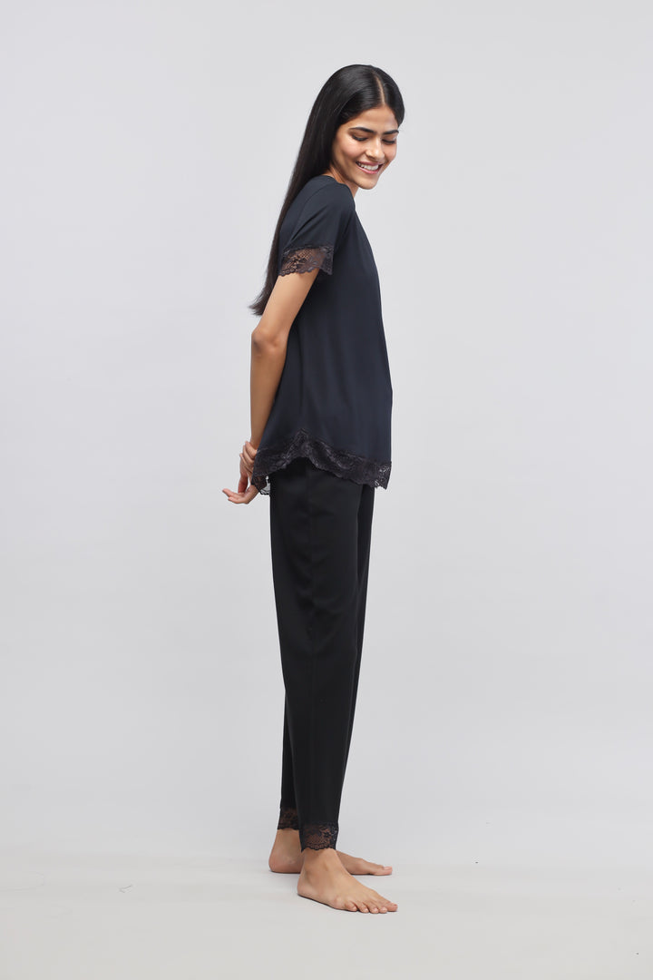 Delicate black lace pajama set featuring short sleeves and elegant lace trim.