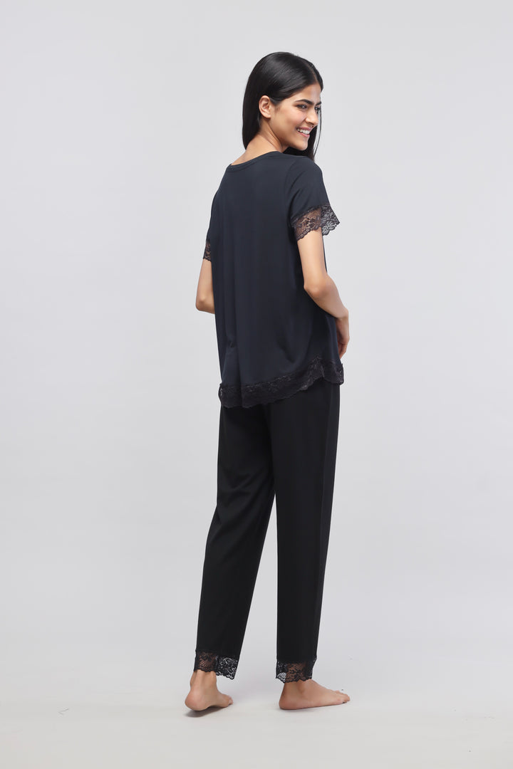 Delicate black lace pajama set with stylish top and pants.