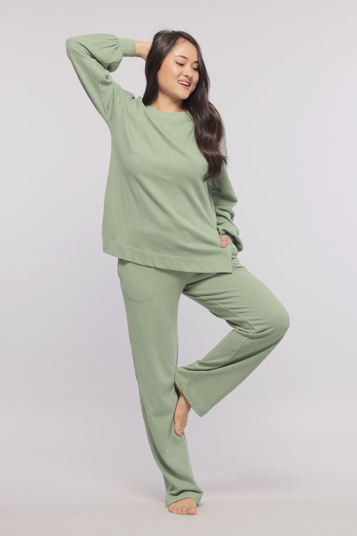 Mint green terry sweatshirt paired with matching sweatpants for comfort.