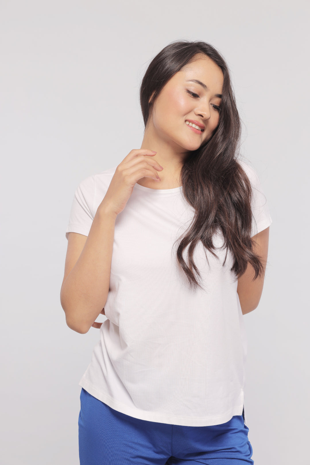 Woman modeling a stylish white monochrome shorts set outfit.