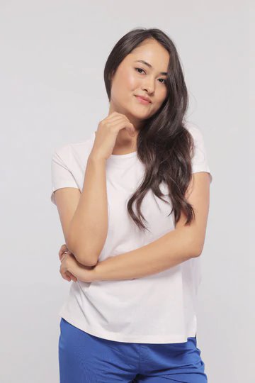 White monochrome shorts set model posing confidently in stylish casual attire.