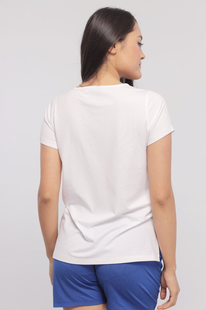 Model wearing a white monochrome shorts set from the back.