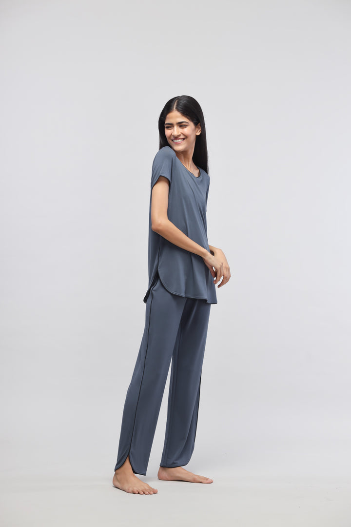 Deep Blue Piping Pajama Set worn by a smiling woman.