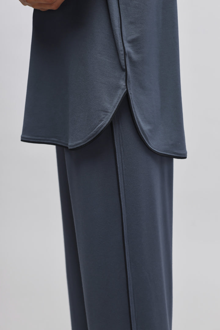 Deep Blue Piping Top featuring curved hem design and stylish pants.