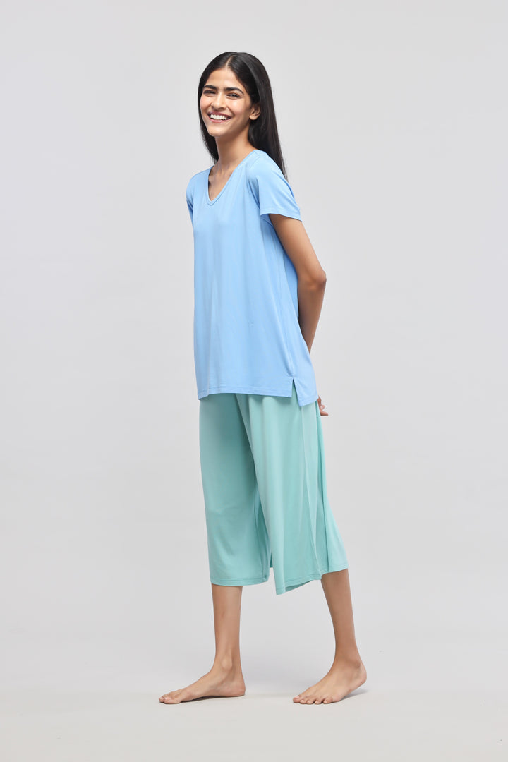 Aqua Culotte Set featuring a smiling woman in stylish loungewear.