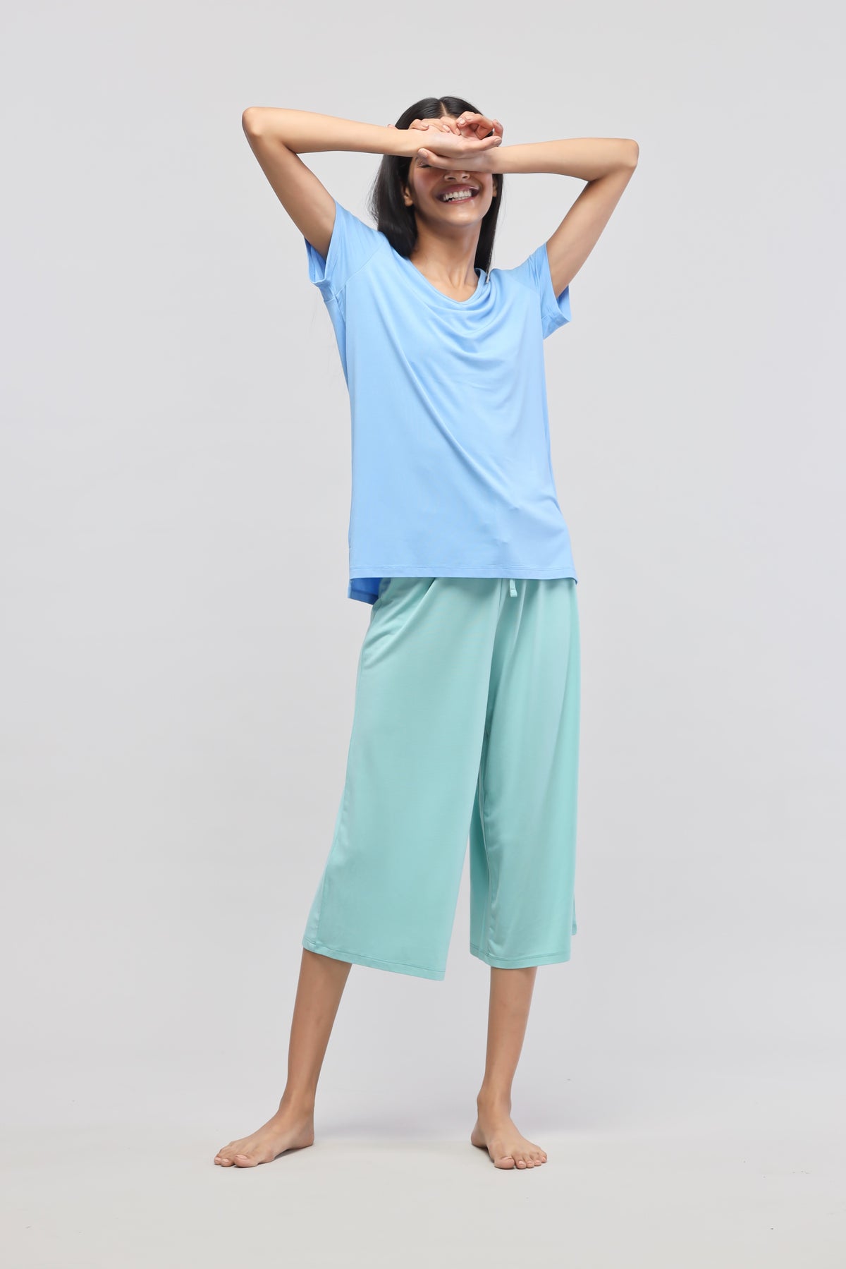 Model showcasing Aqua Culottes with a casual blue top.