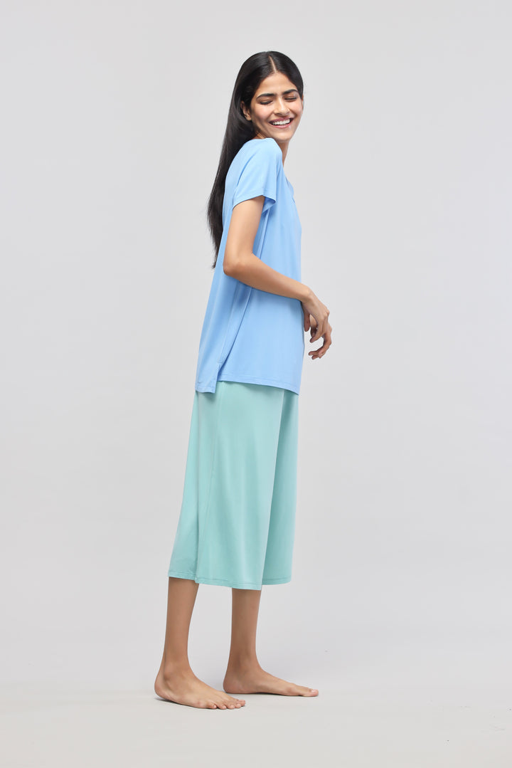 Model wearing Aqua Culotte Set in blue and mint green.