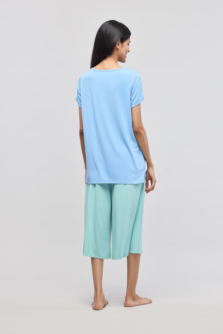 Aqua culotte set featuring stylish blue top and mint green pants.