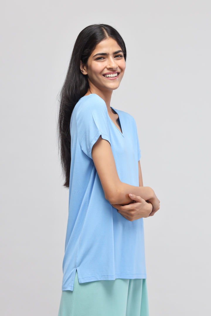 Smiling model wearing the Aqua Culotte Set in blue.