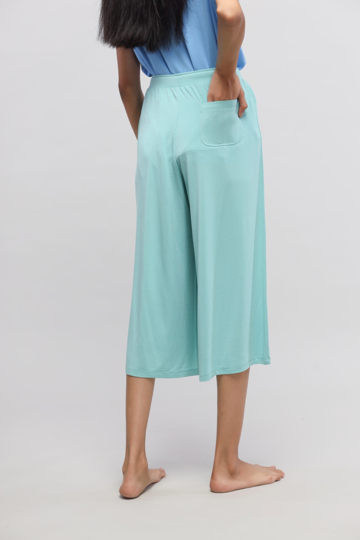 Aqua culotte set showcasing stylish, comfortable culotte pants from behind.