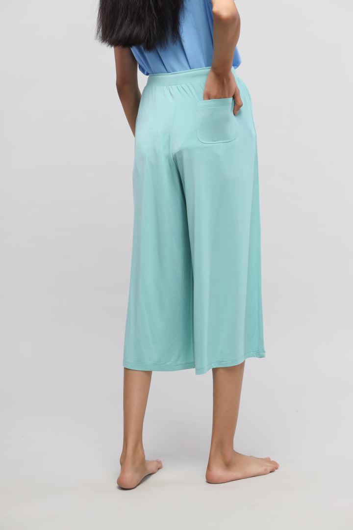 Aqua culotte set showcasing stylish, comfortable culotte pants from behind.