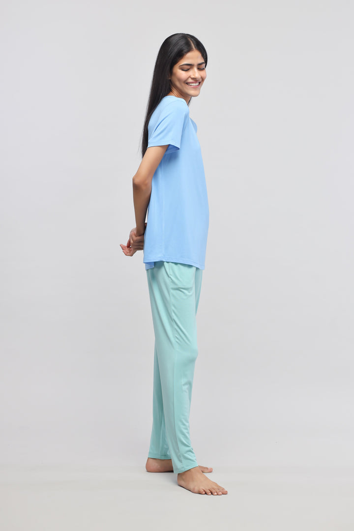 Aqua Straight Lounge Pant worn with a blue top, side view.
