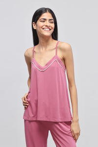 Rosy pink tank top displayed on a smiling model.