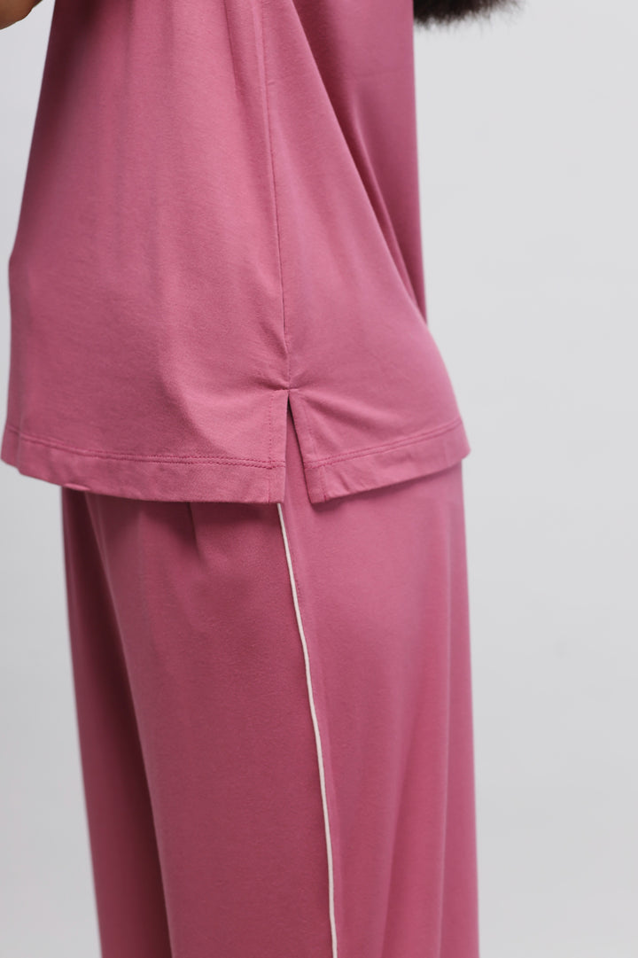 Rosy pink tank top close-up, showcasing soft fabric and stylish design.