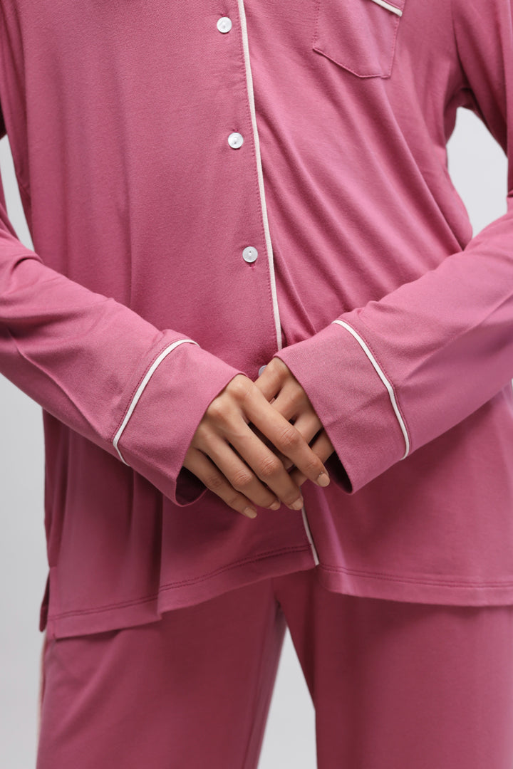 Rosy pink button-down top with full sleeves and piping details.